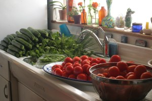 Piles of tomatoes and zucchini from the farmer's market, ready to be preserved