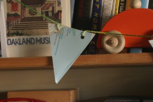 Houseproud homestead project - close-up of garland made from an old map and a long crochet chain. 