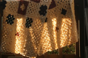 Crocheted throw, made of recycled wool (with centers made of wool from a yarn exchange that someone had dyed with Kool-Aid). 