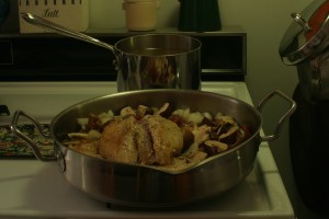 A pot of simmering chicken stock hides behind a skillet of chicken to be braised.  That's a happy sight to see, innit?