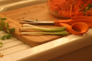 Now that you have a bowl of grated carrots, add some onions.  I used these wonderful green onions that I get from the Jack London Square Farmer's Market, which are more baby onions than scallions.  