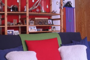 I made that red zippered wool throw pillow case this year, too.  That red really pops, doesn't it?  I knit the throw pillow cases from thick off-white wool a few years ago.  They need button closures, I think (they close in the back like an envelope).  I have green flannel all cut out and ready to be made into small throw pillow cases to replace the blue ones you see here, but I ran out of time.  I'll make the new pillow cases in the coming week or so, in hopes that the green of the flannel inspires Ma Nature to send us some flipping rain already.  