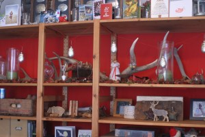 The hutch in the Houseproud homestead's living room, all decked out for Christmas.  Our decorations vary every year - this year's display is a quiet, natural one.  The bulbs in the square vase are paperwhites, courtesy someone at St. Joseph's who's a wonderful gardener.  The cutout elk and bear are three-dimensional pieces from a Japanese calendar that I bought at the Oakland Museum of California's gift shop a few years ago - they can be folded in a way that doesn't display the calendar.  On top of the hutch are the cards we received this year.  My favorite is the one made by mum-of-mine (it's the one on the far right, the dove carrying an olive sprig).  