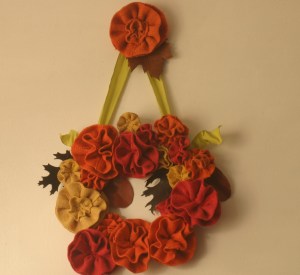 It's finished!  Hurrah, the fall flower wreath is done, and JUST in time for Thanksgiving dinner!  The scrap-leather leaves slay me, really they do (although their placement irks me, but as I am so done with this bloody thing for the season, they can stay where they are).  